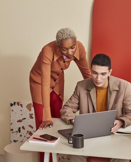 Two people at a computer discussing how to make their site more accessible.